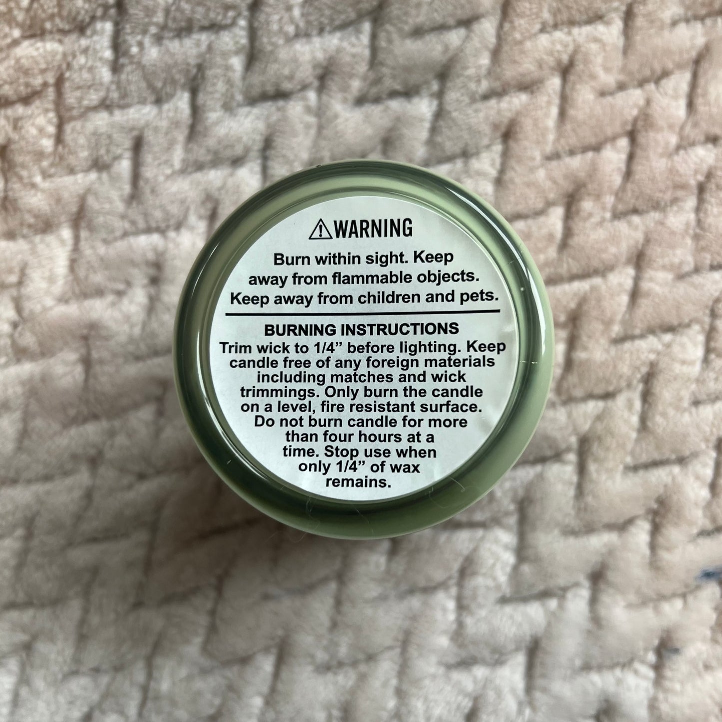 Back of a candle, showing the instructions  and warnings
