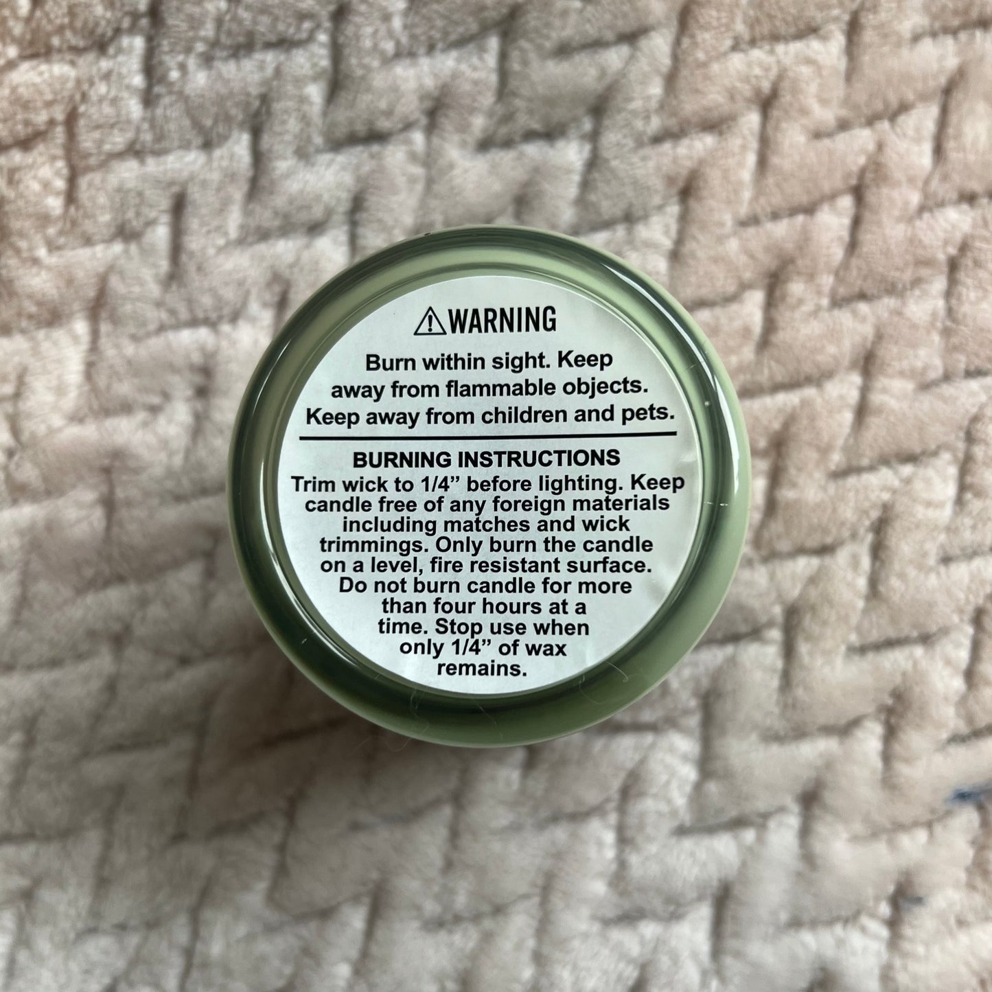 Back of a candle showing the burning instructions and warnings