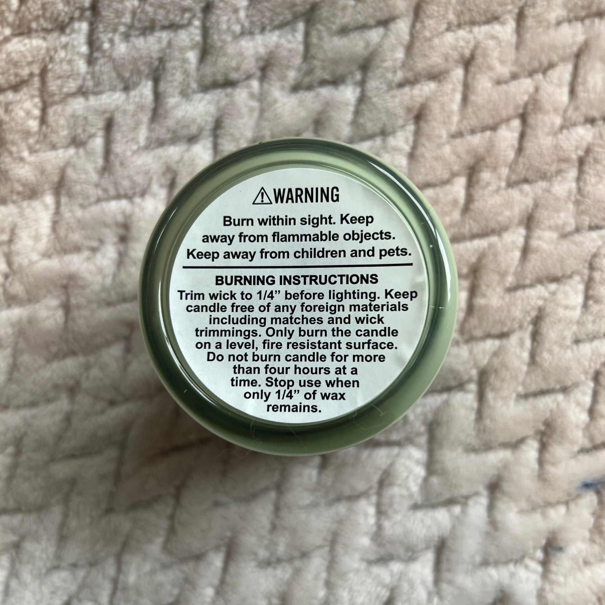 Back of a candle showing the burning instructions and warnings